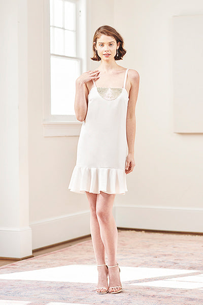 mini white beaded bridal slip dress styled with Stuart Weitzman sandals and drop earrings