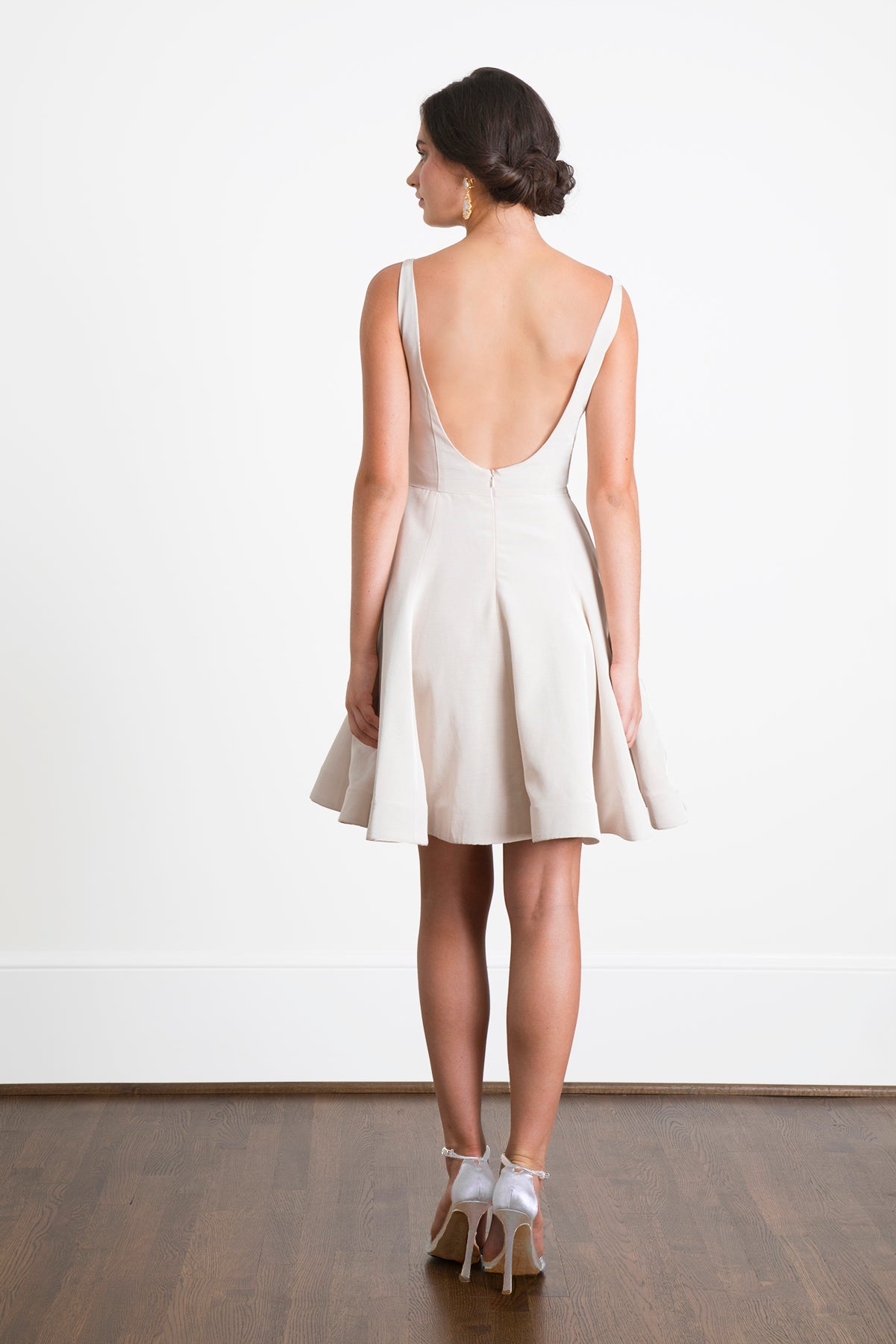 Bride to be wearing backless white short and simple elegant wedding dress 