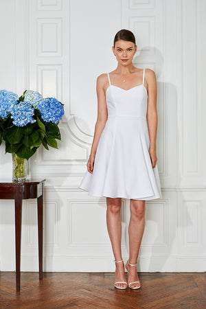 bride wearing sophisticated short white rehearsal dinner & wedding dress with sweetheart neckline front view