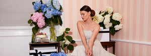 beautiful bride in stunning strapless sequin designer wedding reception and first dance dress surrounded by flowers