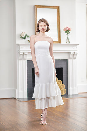 bride wearing sophisticated short white rehearsal dinner & wedding dress with strapless double flounce mermaid style