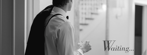 groom waiting for bride wearing white strapless tea length wedding dress