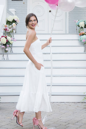 Bride in casual simple white strapless tea length midi ruffle flowy flattering rustic romantic outdoor wedding dress 
