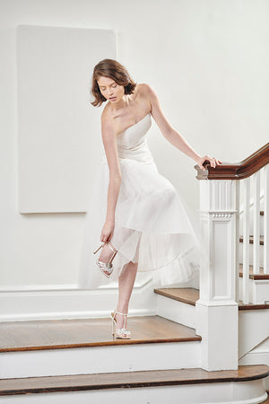 bride in white tulle strapless civil wedding rehearsal dress and fun romantic first dance reception dress fixing shoe