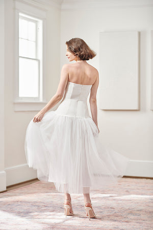 bride twirling in fun flattering simple white strapless bustier midi wedding rehearsal dress